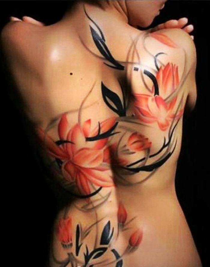 black and red flower tattoo on half of back