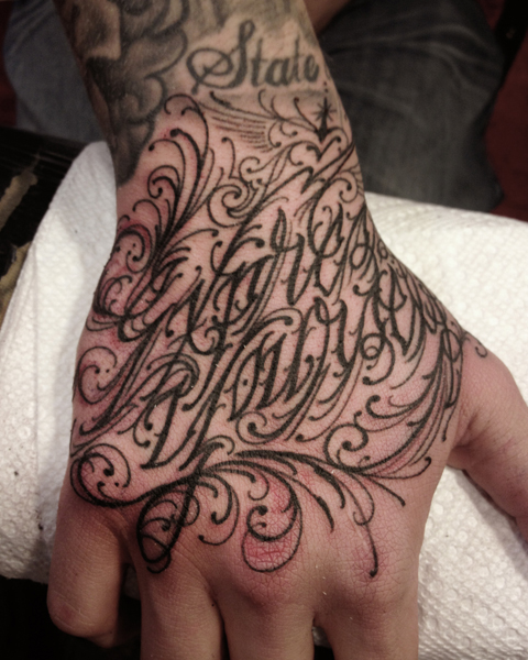 Back of the Hand Lettering tattoo by Three Kings Tattoo