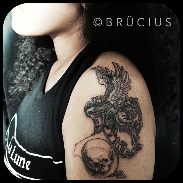 Skull Holding Gryphon Shoulder tattoo by BRÜCIUS