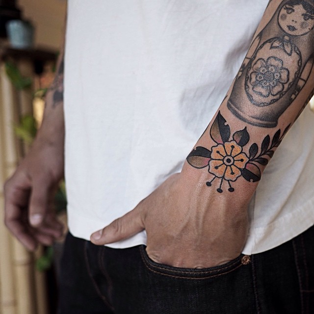 Yellow Traditional Flower Wrist tattoo