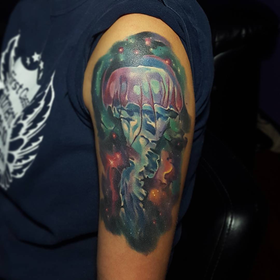 Jellyfish tattoo in space on shoulder