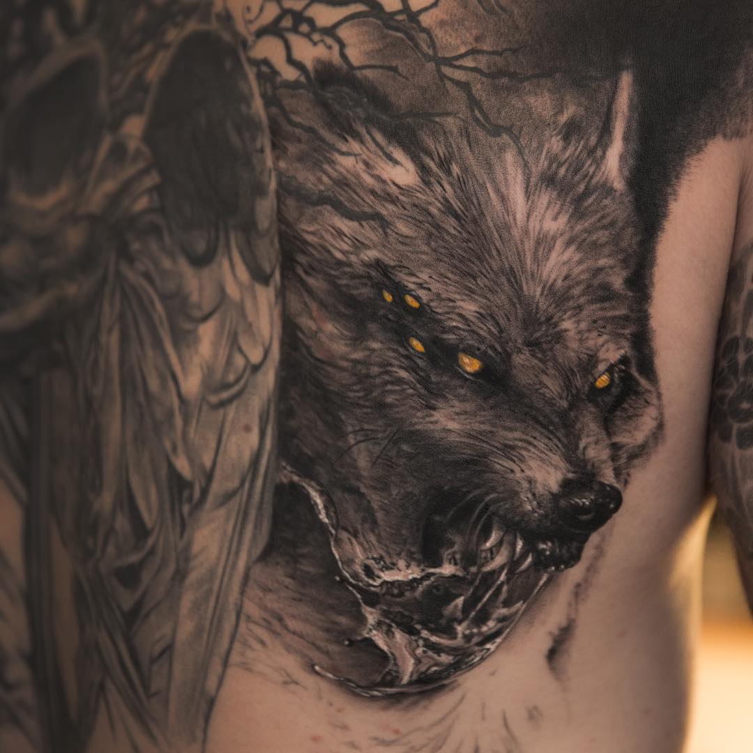 very angry looking Fenrir Tattoo inspired by Scandinavian Mythology. Realistic black and grey tattoo