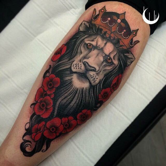 lion with crown tattoo on calf