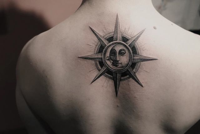 back tattoo of star with moon and sun