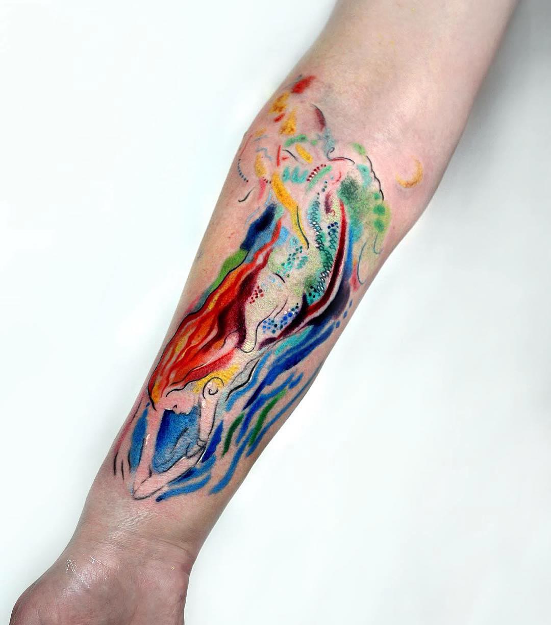 watercolor mermaid tattoo on forearm