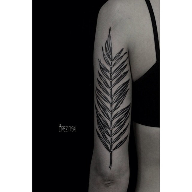 leaf tattoo on the back of the arm
