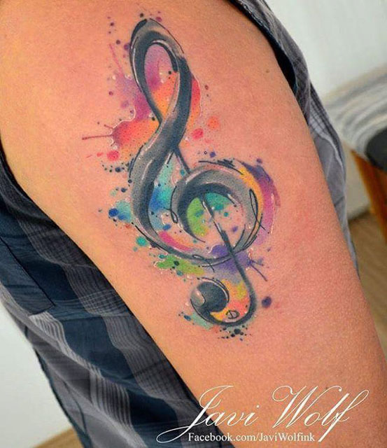 Tattoo of a bass and treble clef heart located on the