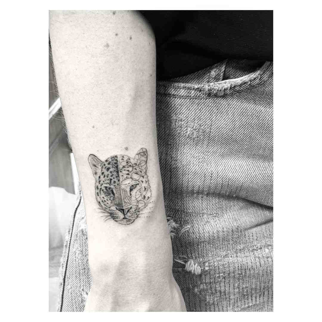 cougar face tattoo on arm