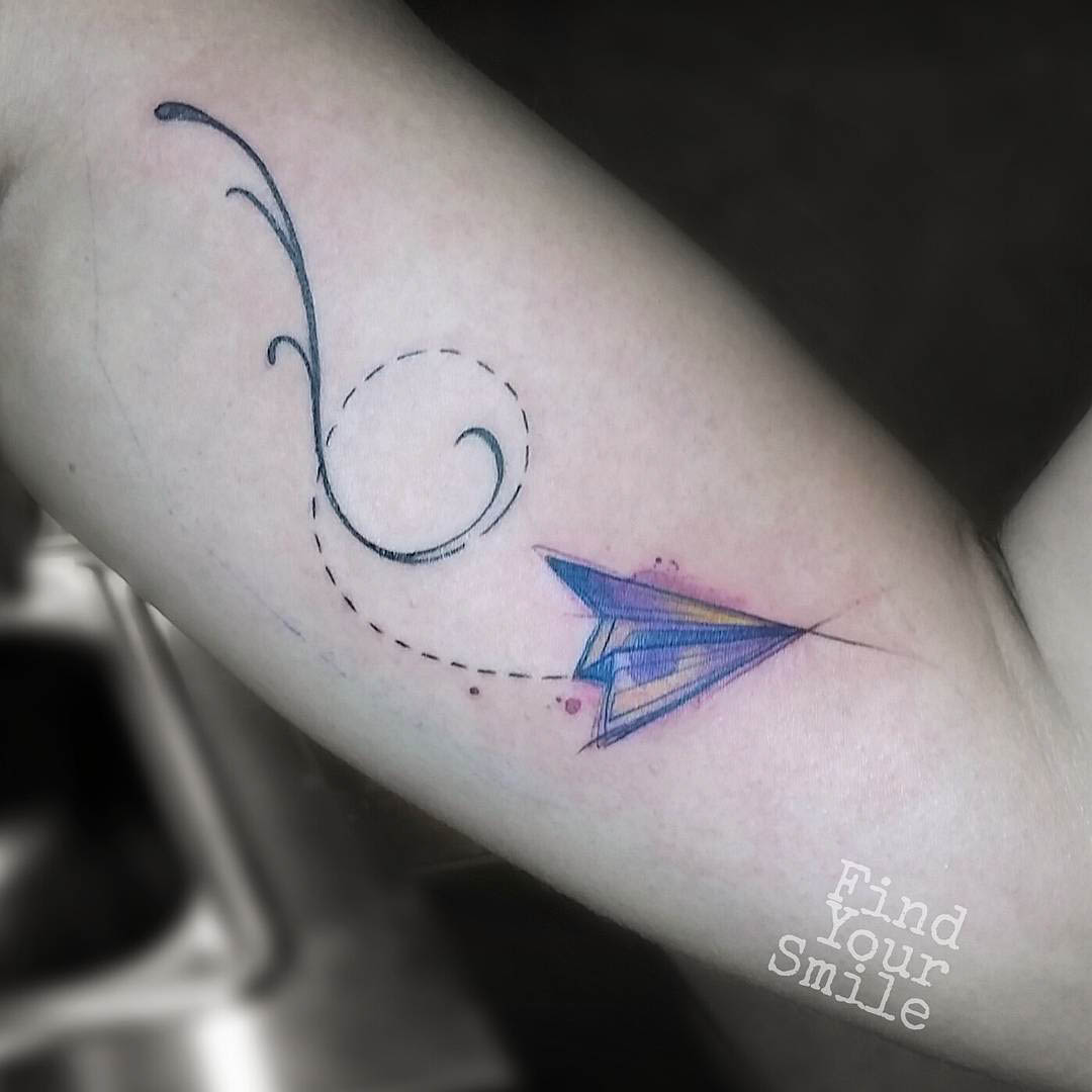 paper plane tattoo on arm