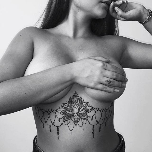 baroque girl tattoo under breast.