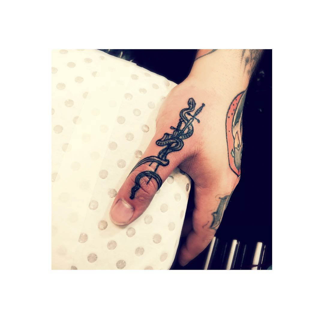 Thumb Tattoo on finger