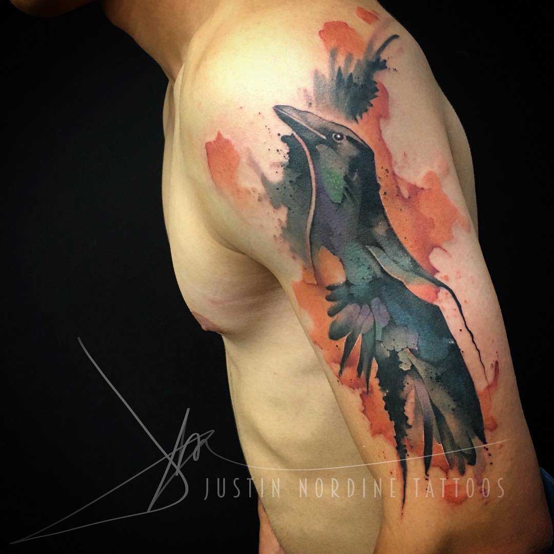 watercolor raven tattoo on shoulder