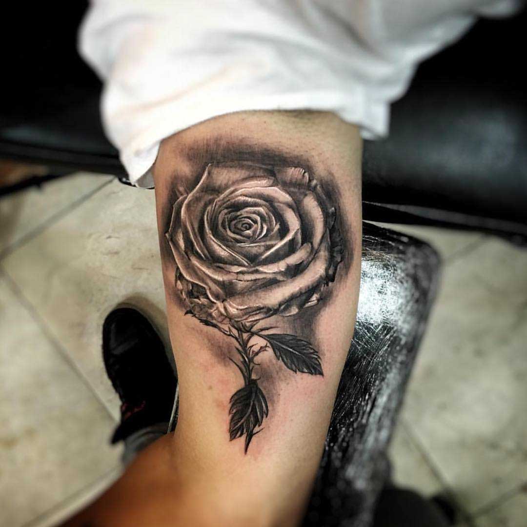 rose tattoo on inner bicep
