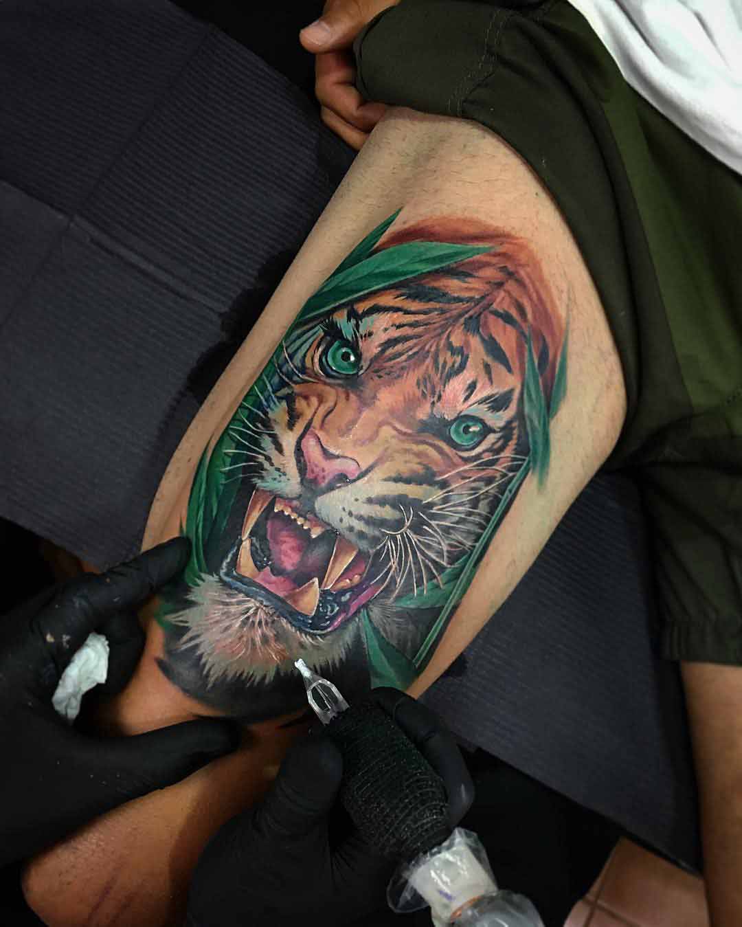 angry tiger tattoo on thigh