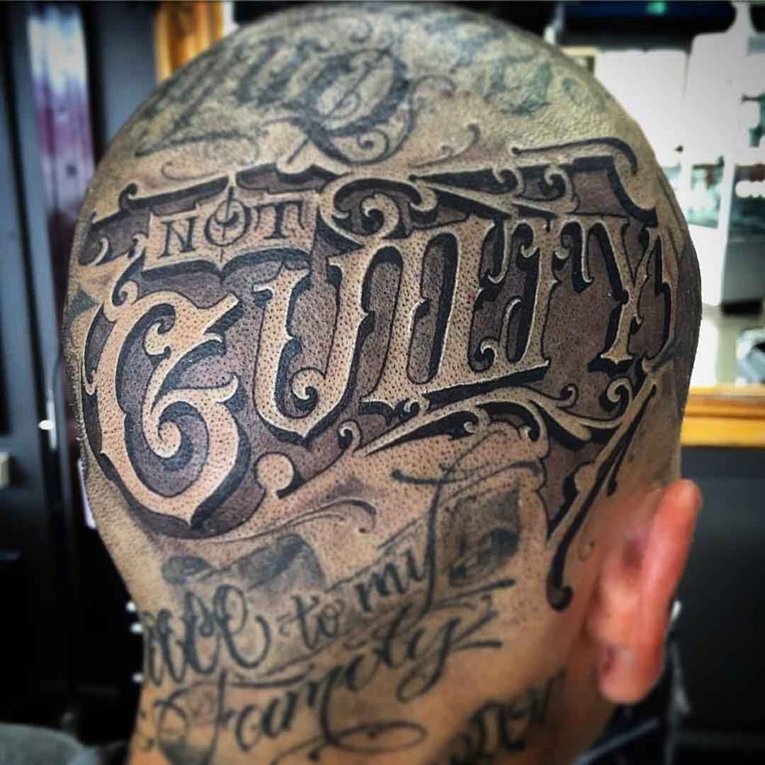 lettering head tattoo on guilty