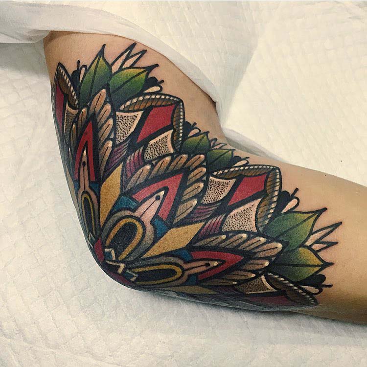 neo-traditional tattoo on elbow