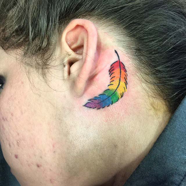 rainbow deather tattoo behind ear very colorful