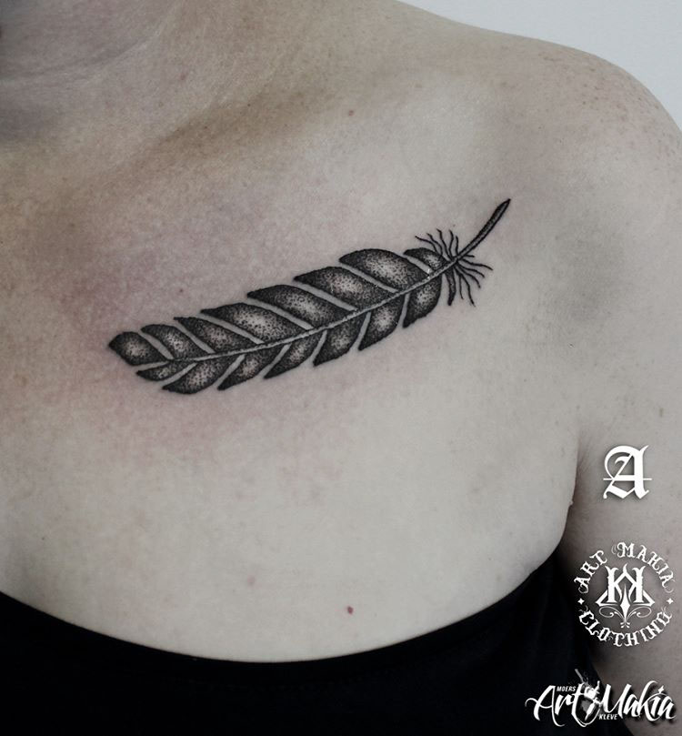 collar bone tattoo of feather