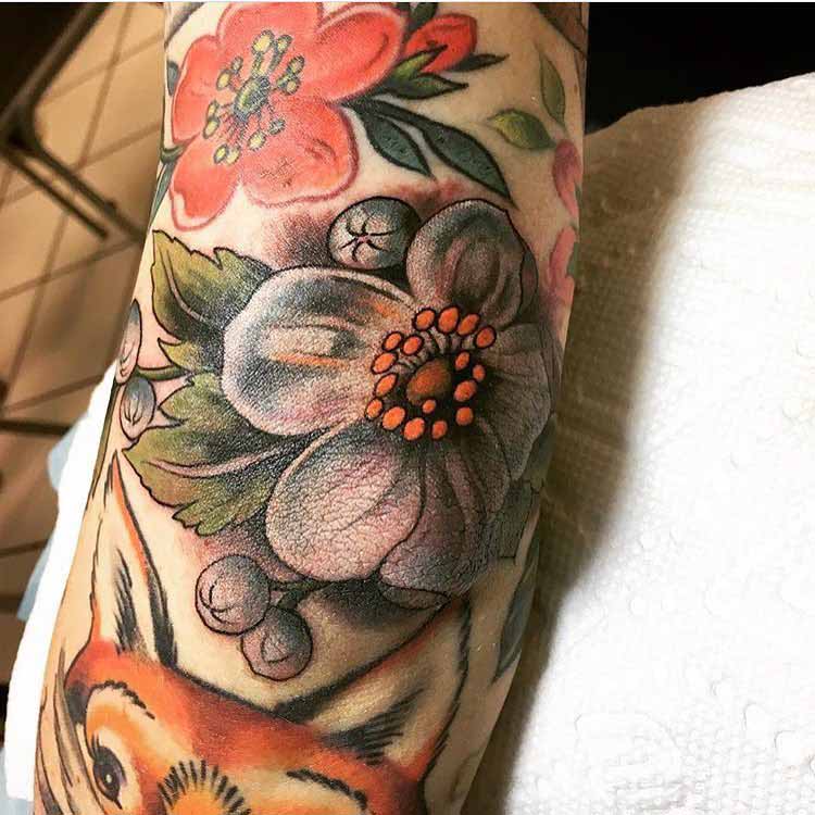 flower tattoo on elbow realistic style