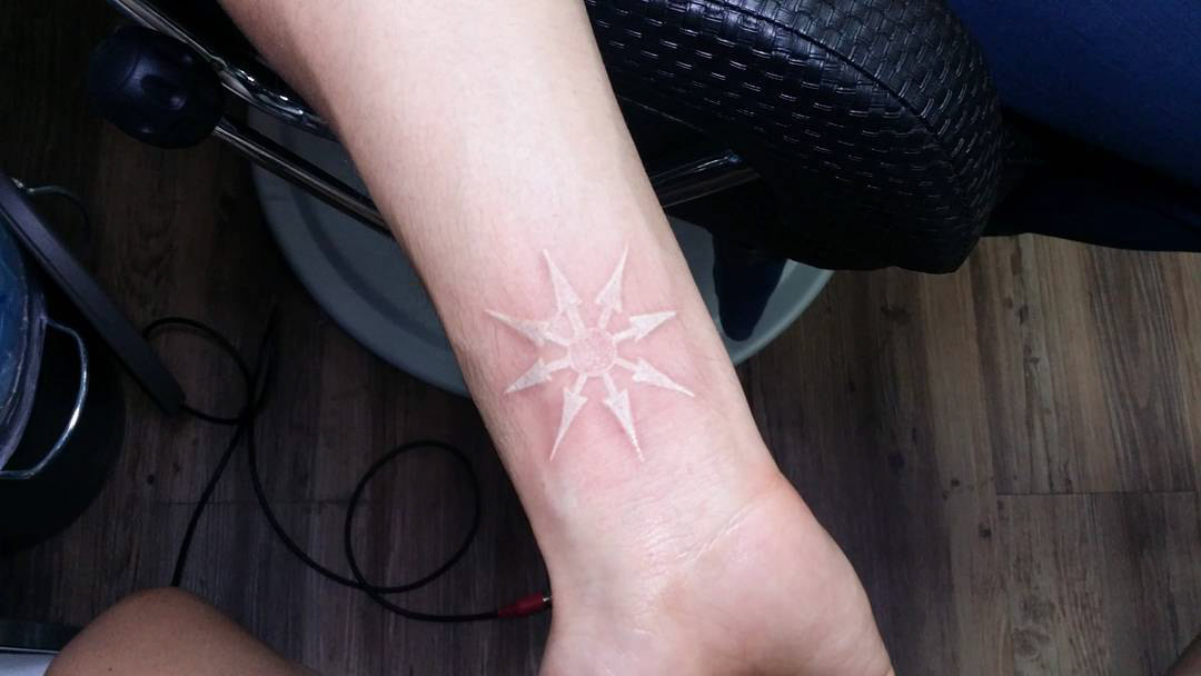 white tattoo on the wrist