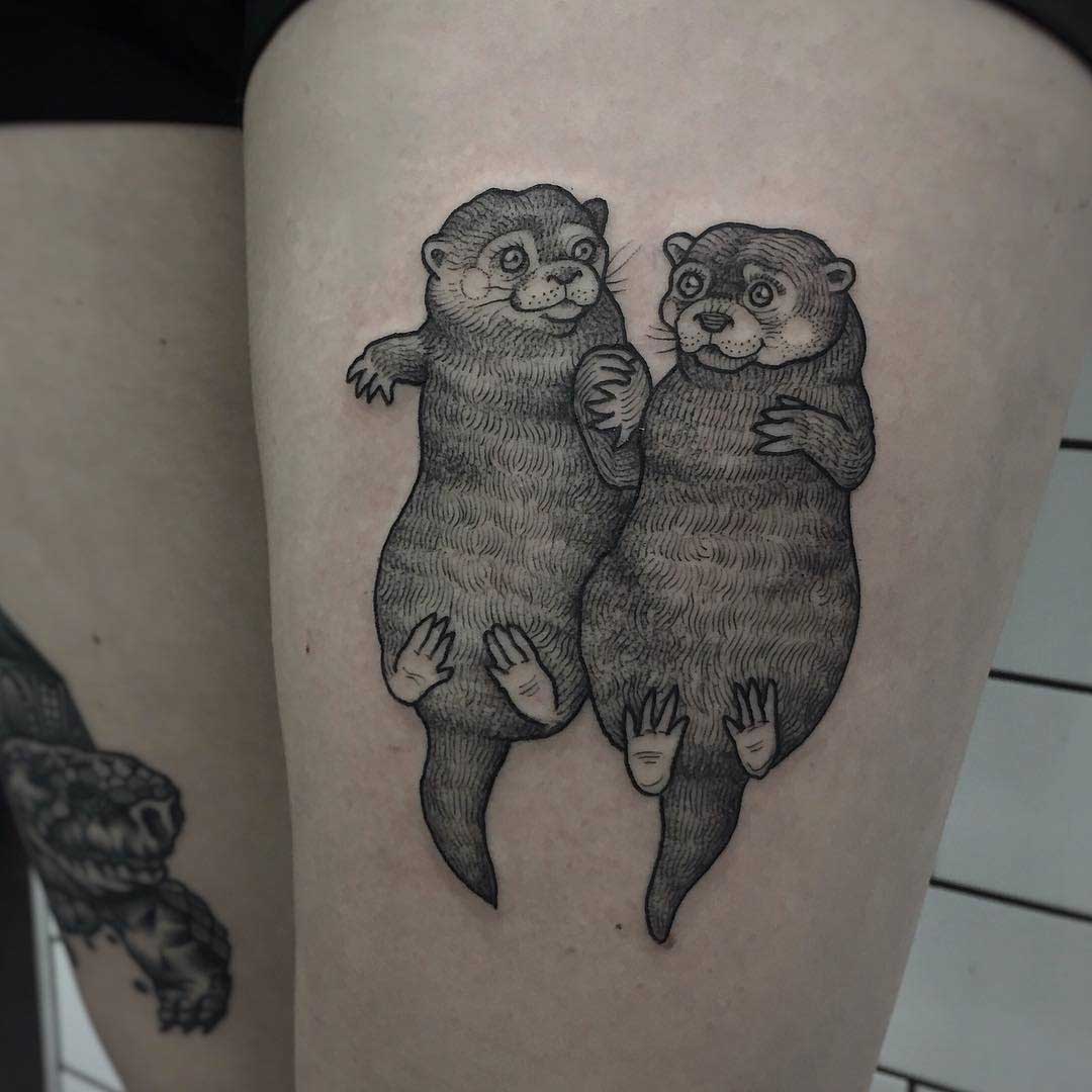 otters tattoo holding hands