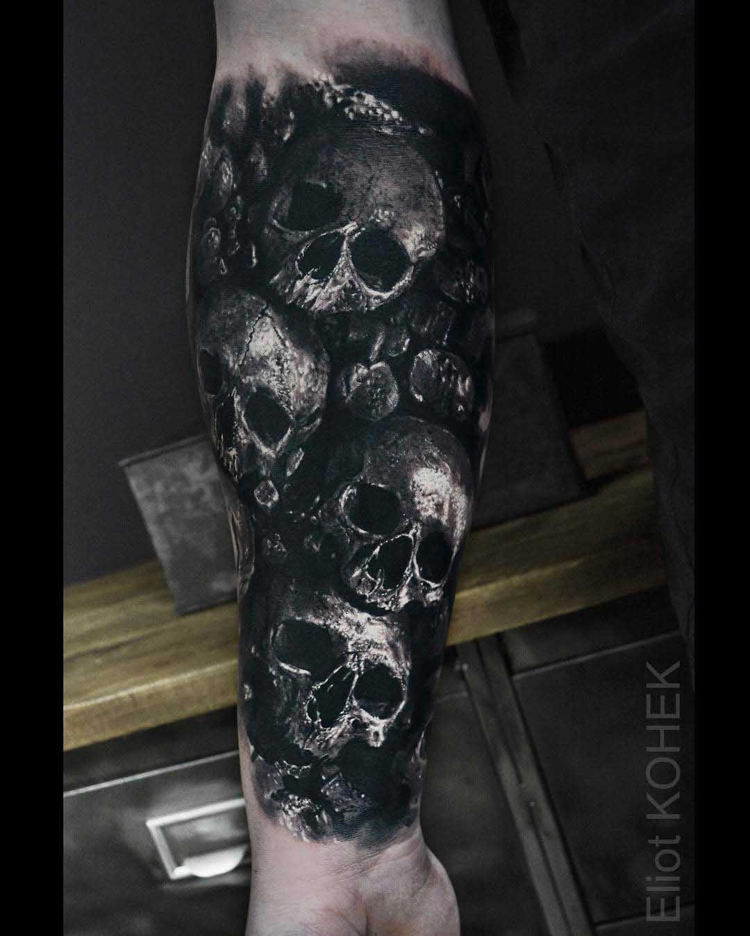 a lot of skulls tattoo on arm