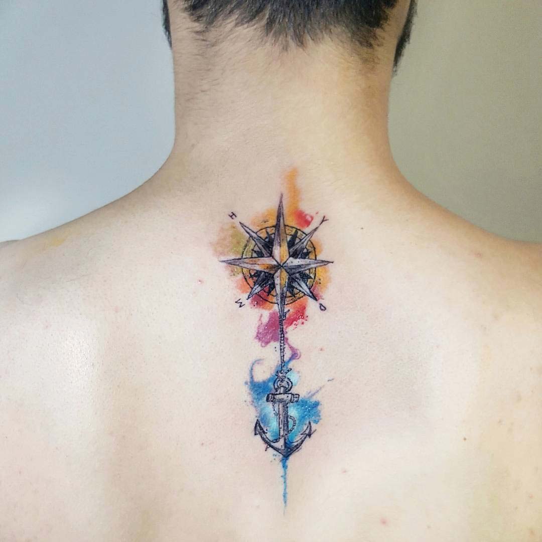 nautical watercolor tattoo on spine compass and anchor