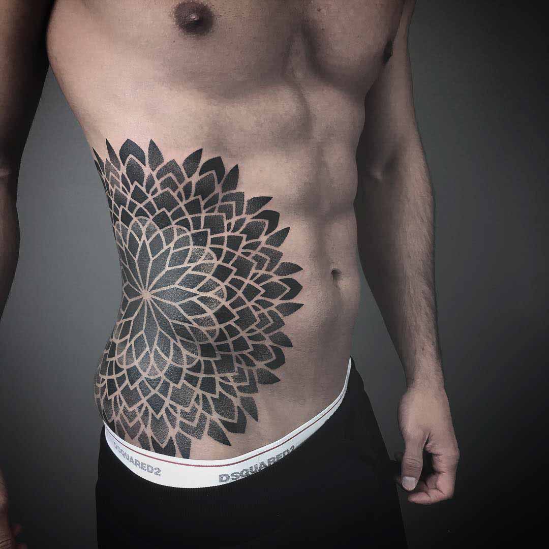 dotwork mandala tattoo on stomach side.