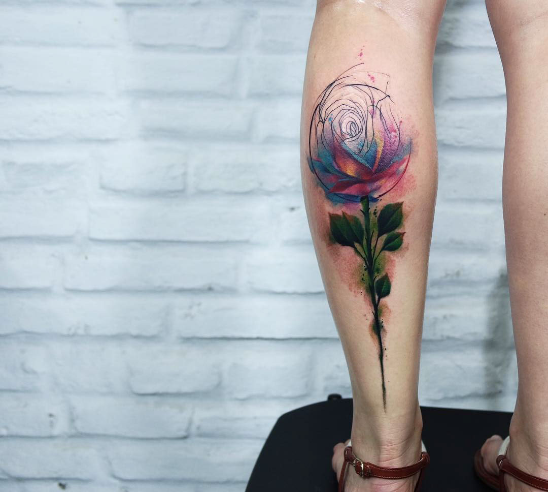 watercolor style rose tattoo on calf