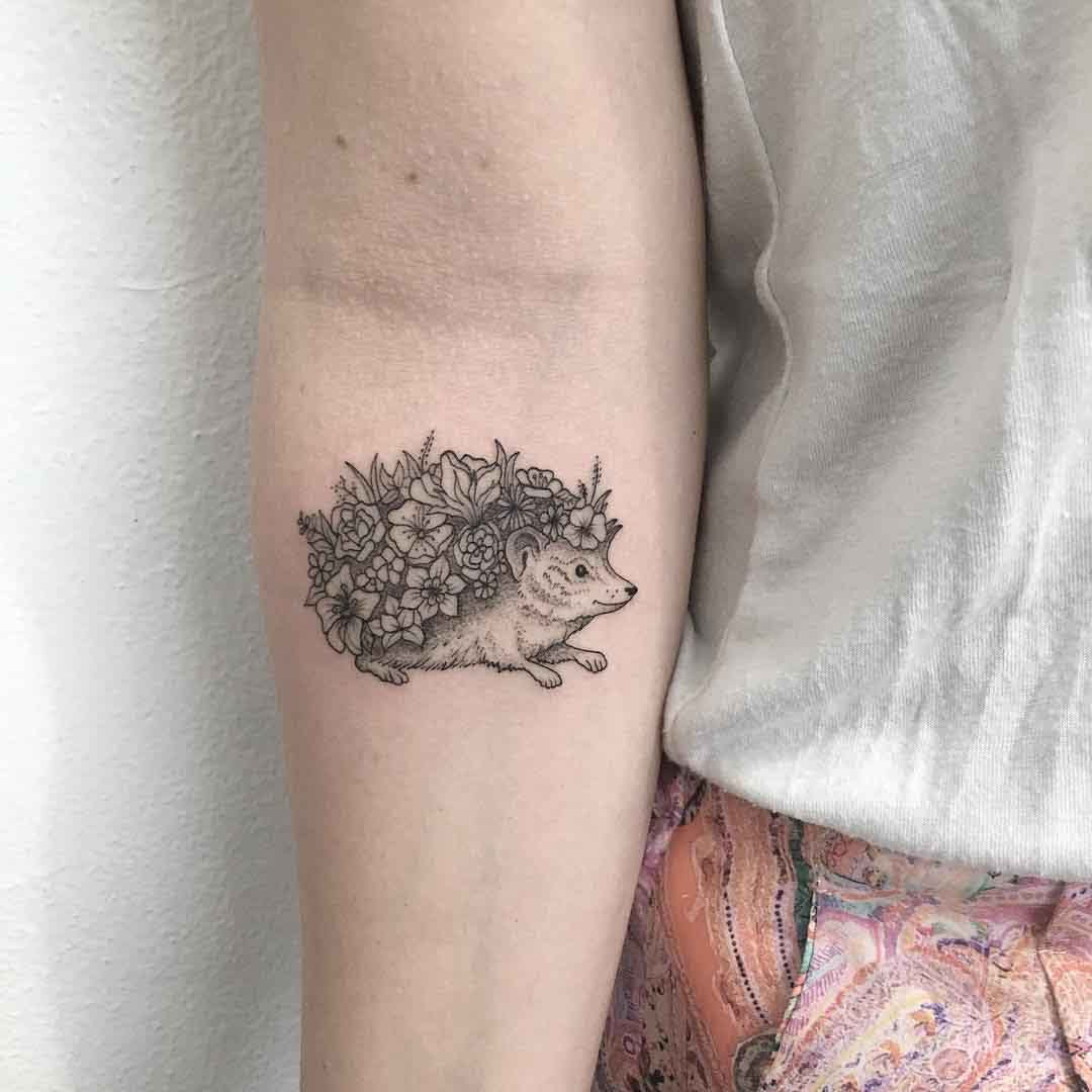 inner elbow hedgehog tattoo with flowers