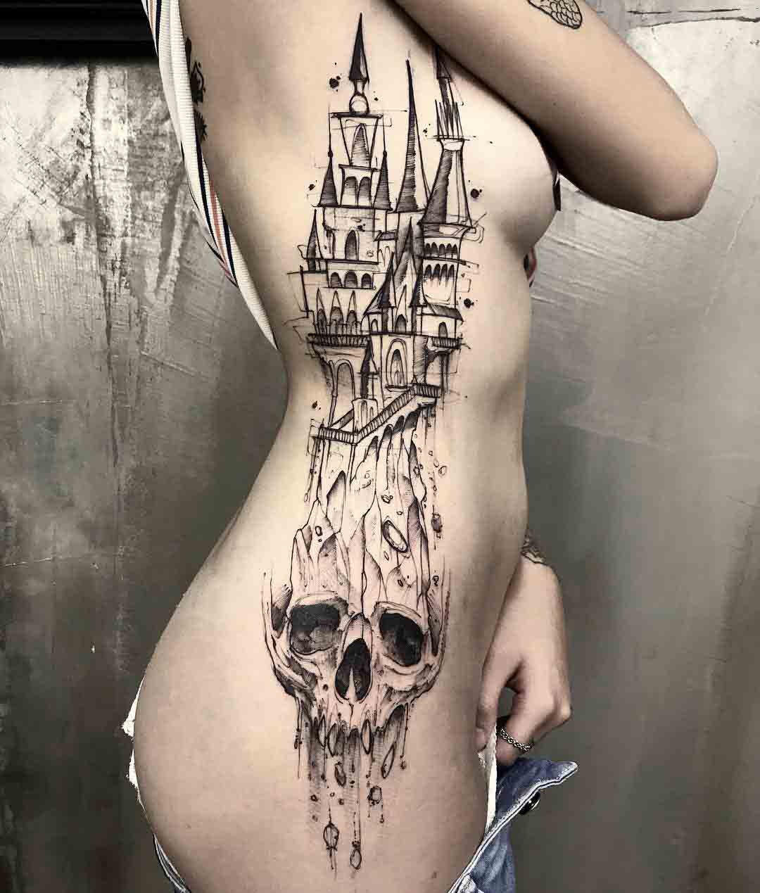 castle skull tattoo on girl's side