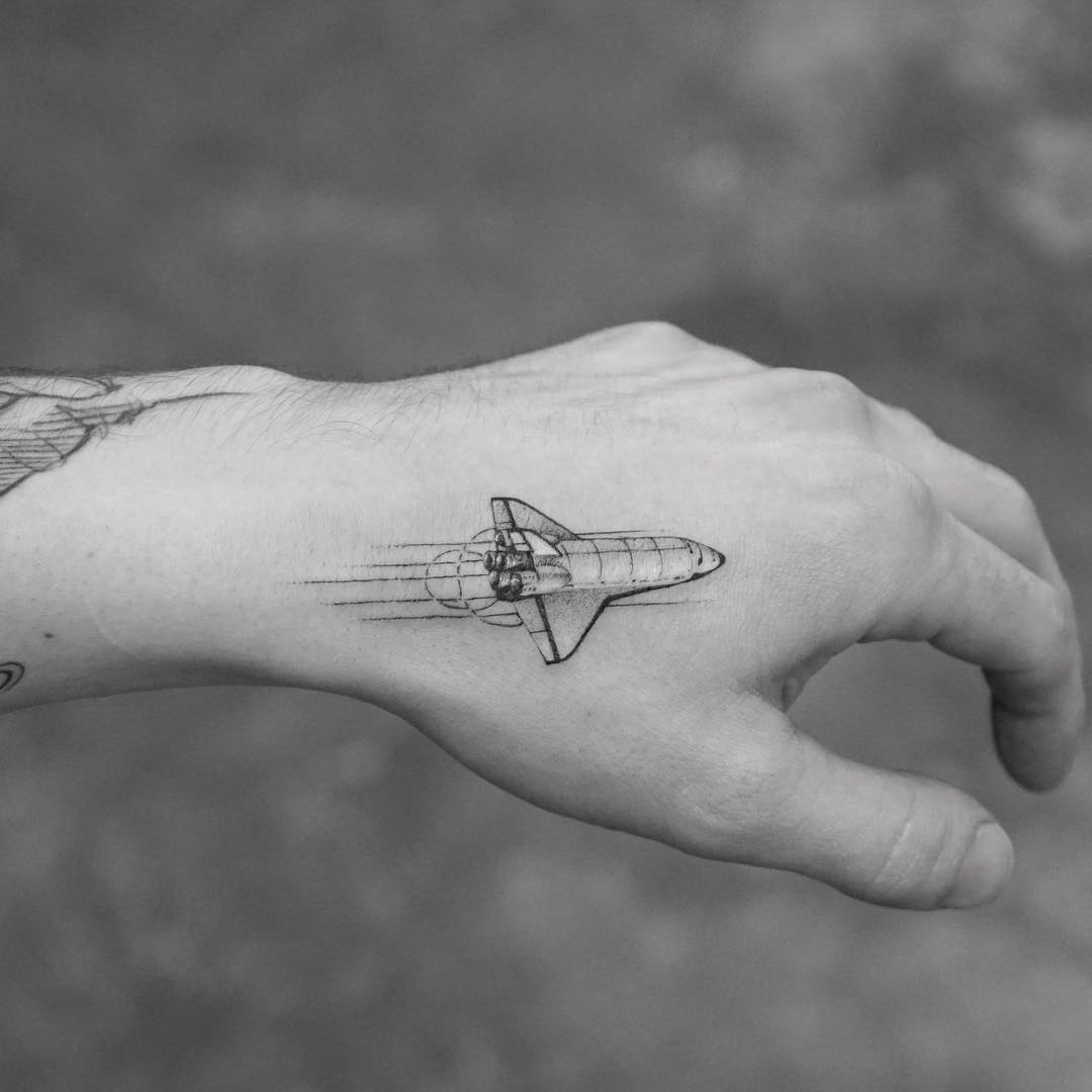 small shuttle tattoo.