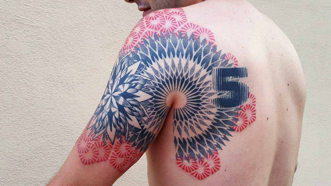 mandala tattoo on shoulder blade and back of arm