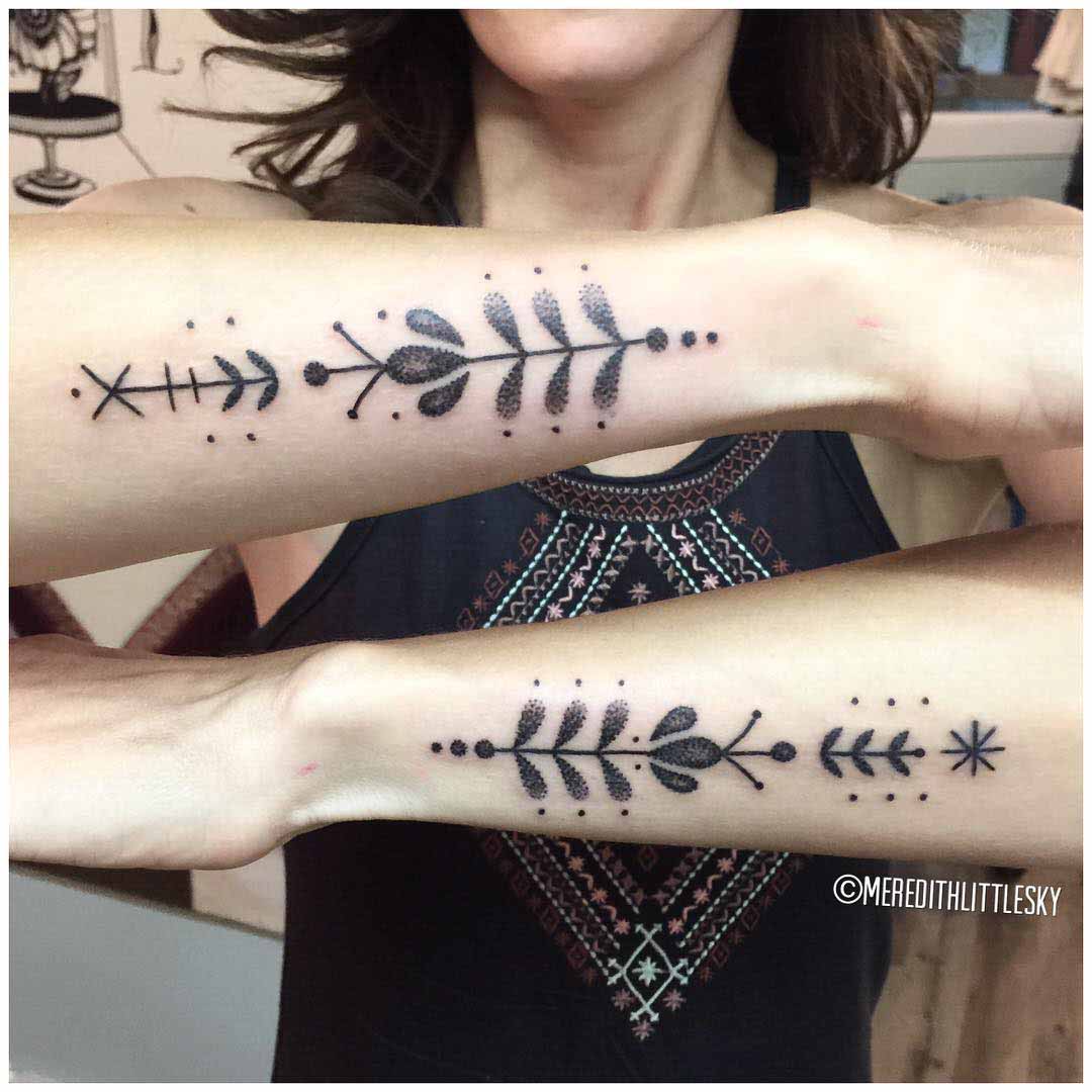 dotwork feminine tattoo ornament on forearms