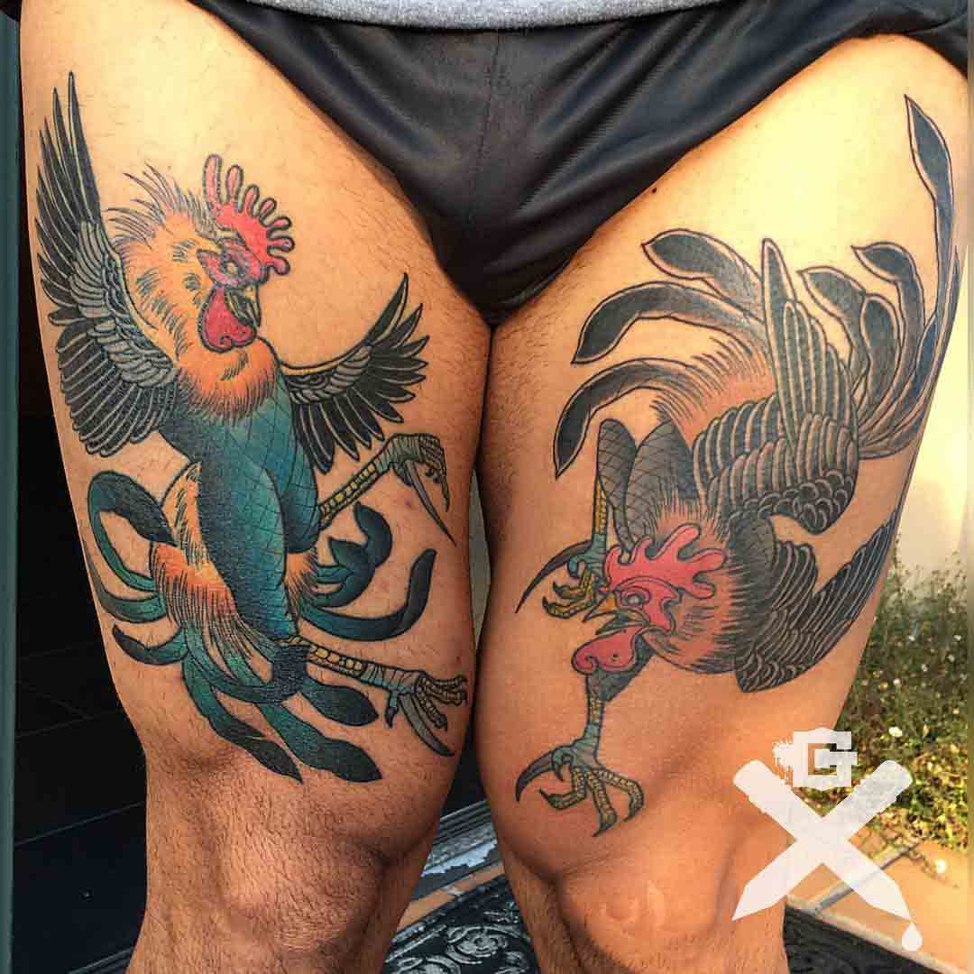 thigh tattoos fighting roosters.