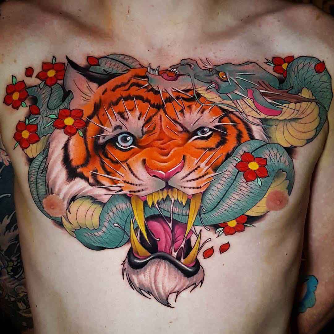 chest tattoo tiger eating snake