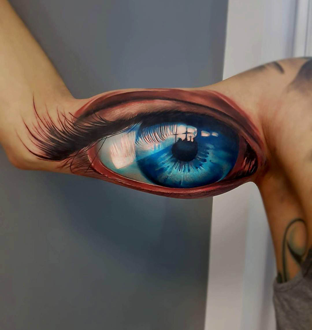 bicep tattoo blue eye