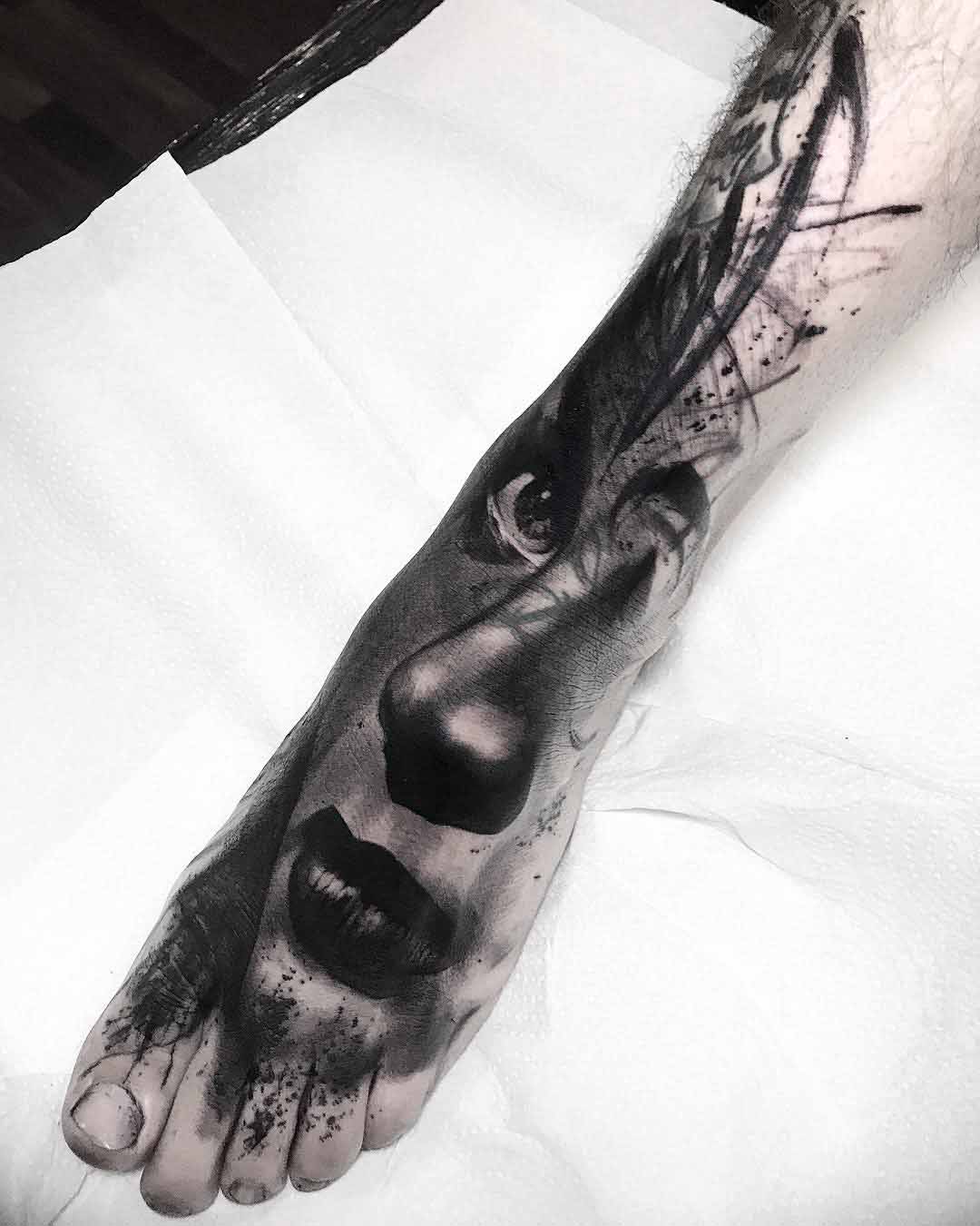 grey foot tattoo portrait