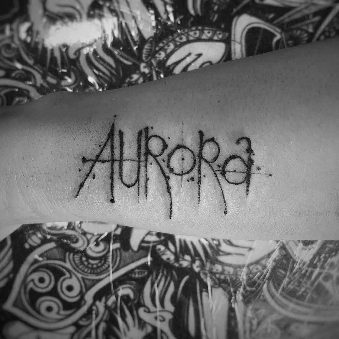 arm tattoo aurora lettering