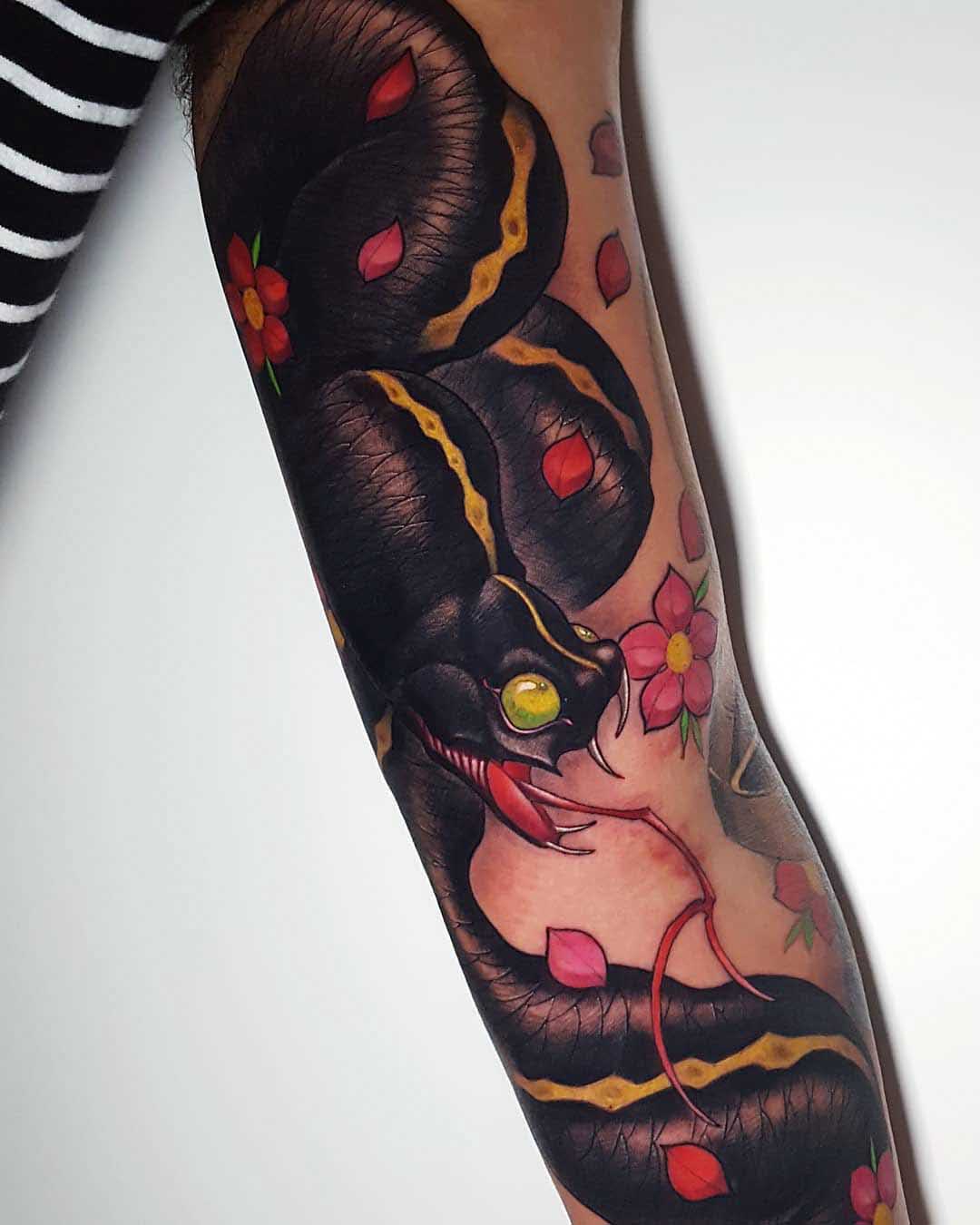 black snake tattoo on inner arm