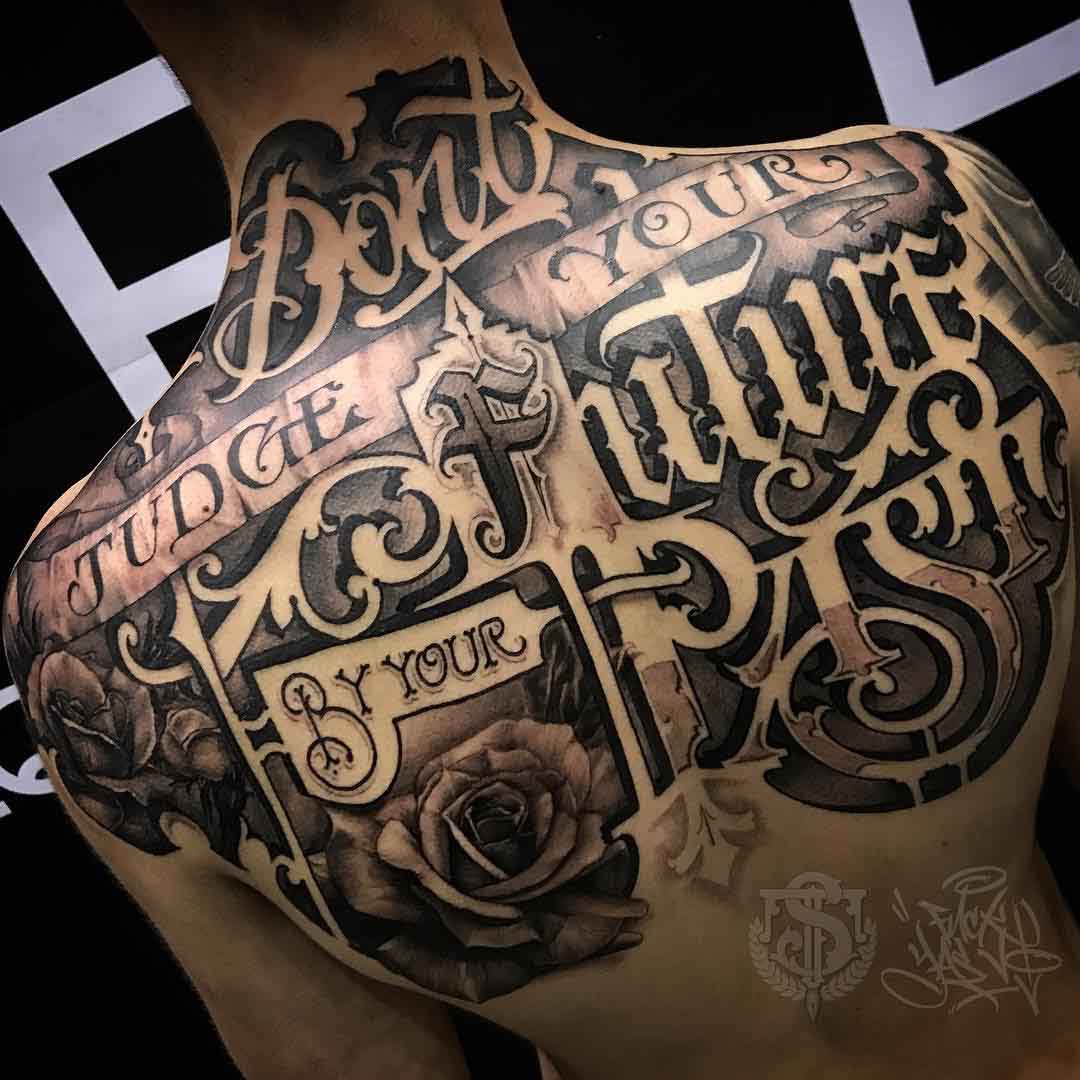 lettering tattoo on the upper back