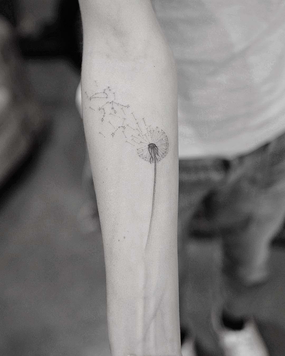 dandelion tattoo on arm