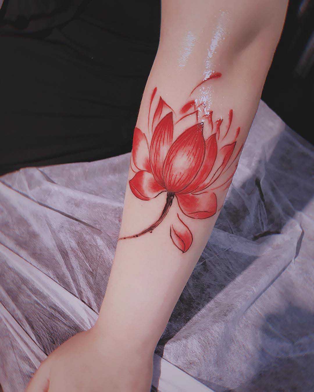 arm tattoo red lotus
