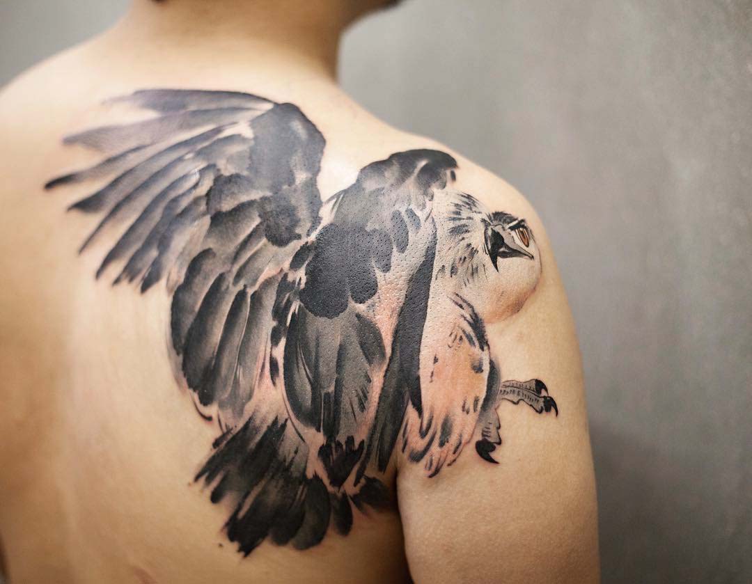 hawk tattoo on back of shoulder